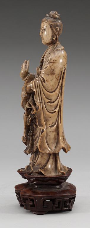 A stone sculpture of Guanyin, Qing dynasty (1644-1912).