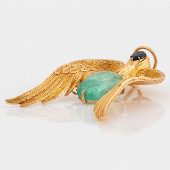 A 14K gold pendant by Salvador Dalí set with a cabochon-cut emerald and a faceted sapphire.