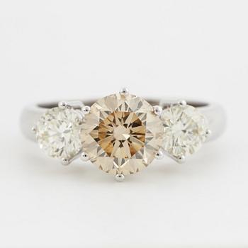 Fancy light yellowish brown round brilliant-cut diamond ring.