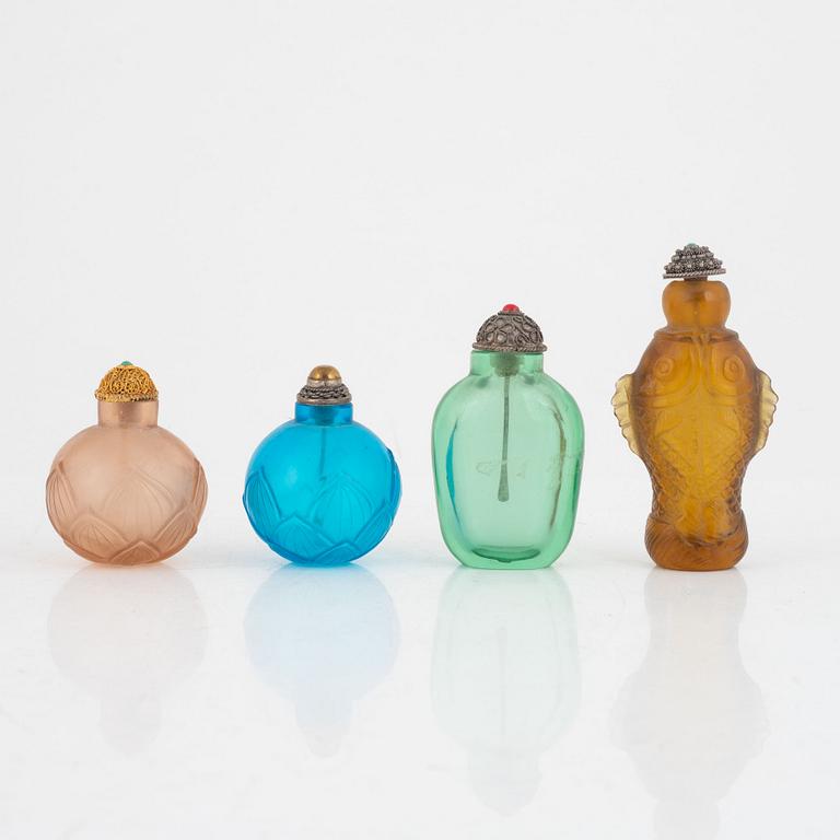 A group of four glass snuff bottles with stoppers, China, 20th century.