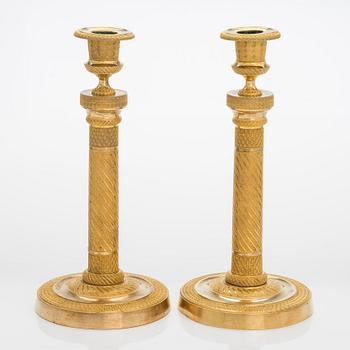 A pair of  French gilded Empire candlesticks, early 19th century.