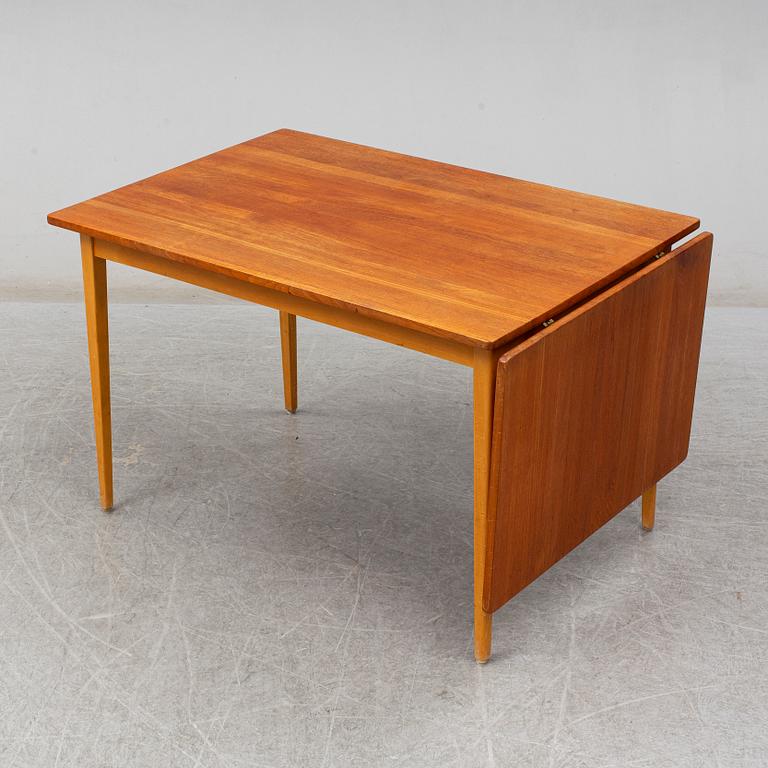 A 1960s teak veneered dining table.