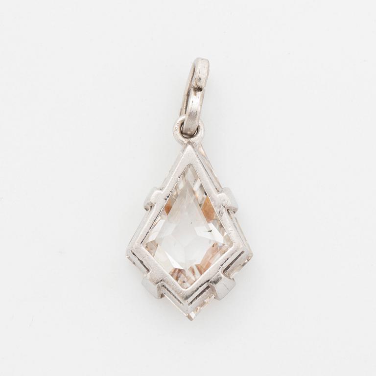 A platinum and step-cut diamond pendant.