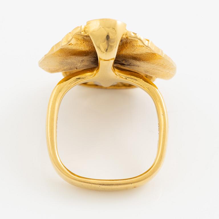 A ring, 18K gold with a fancy-cut smoky quartz and round brilliant-cut diamonds.