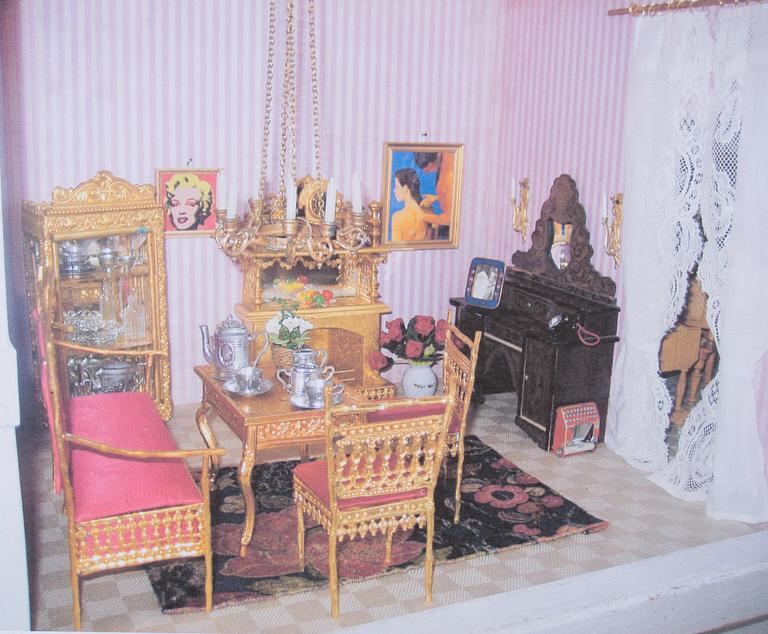 A doll house with interior and dolls ca 1910.