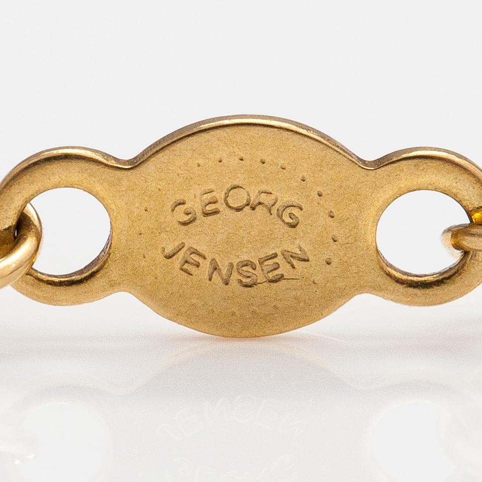 Georg Jensen, An 18K gold bracelet "Magic" with a cultured pearl and diamonds ca. 0.048 ct in total, Denmark.