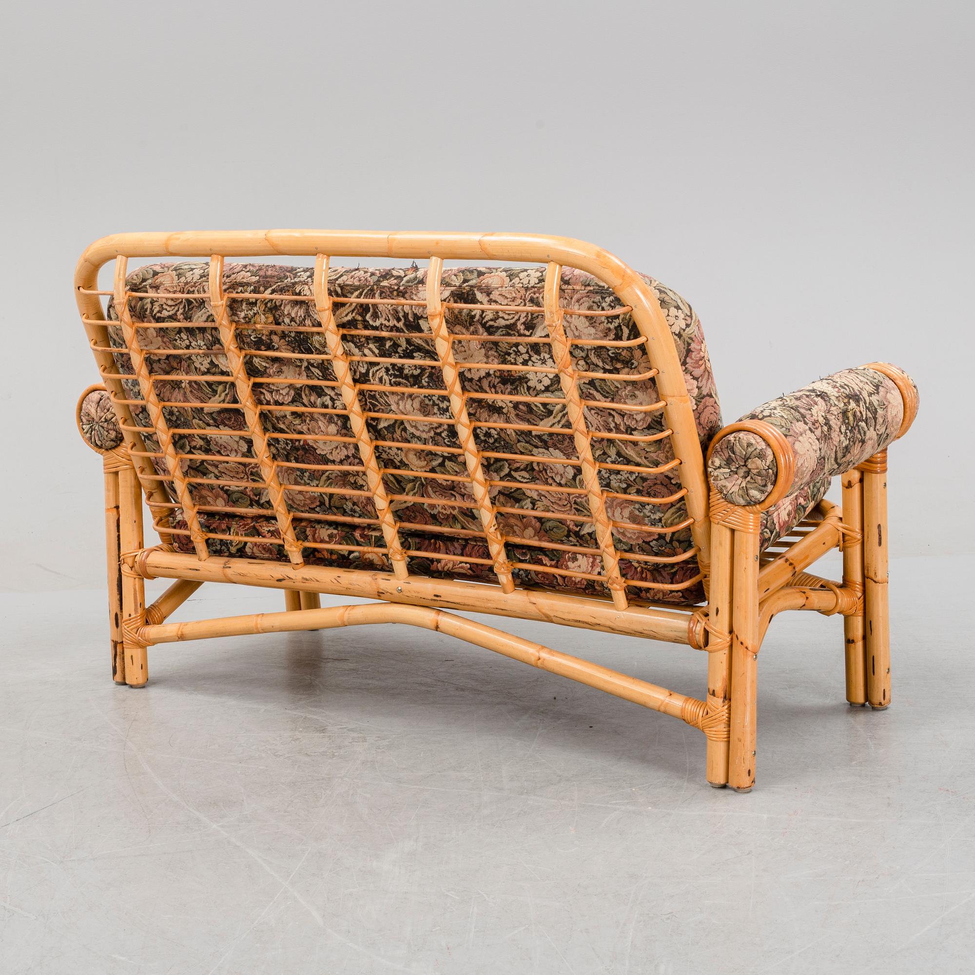 A set of two garden sofas, an armchair and a glass table, later part of the 20th Century.