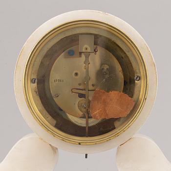 An alabaster mantle clock and pair of candlesticks, circa 1900.