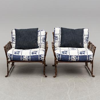 A Pair of contemporary garden easy chairs in metal imitating bamboo.