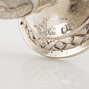 Three Silver Shakers and a Beaker.