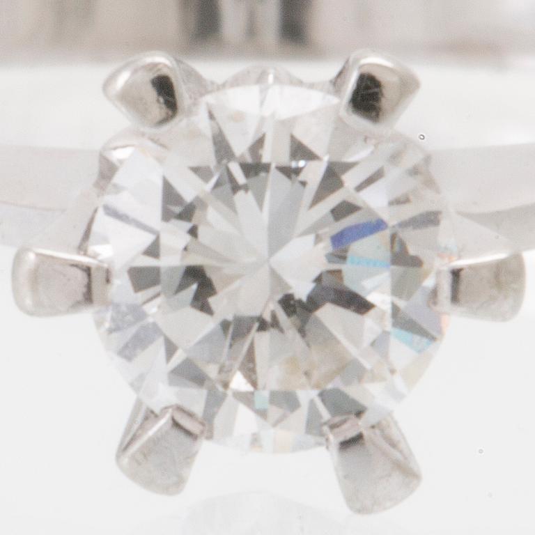 An 18K white gold solitaire ring set with a round brilliant-cut diamond.