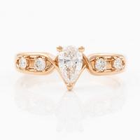 Ring 14K rose gold with a pear-shaped diamond and brilliant-cut diamonds, accompanied by an IGI report.