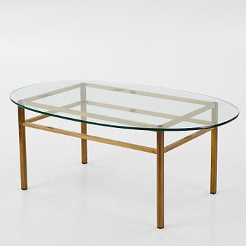 A 1970's glass and brass coffee table.