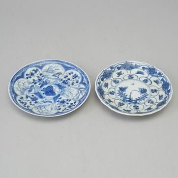 Two blue and white dishes and two cups with dishes, Qing dynasty, Qianlong (1736-95) and Kangxi (1662-1722).