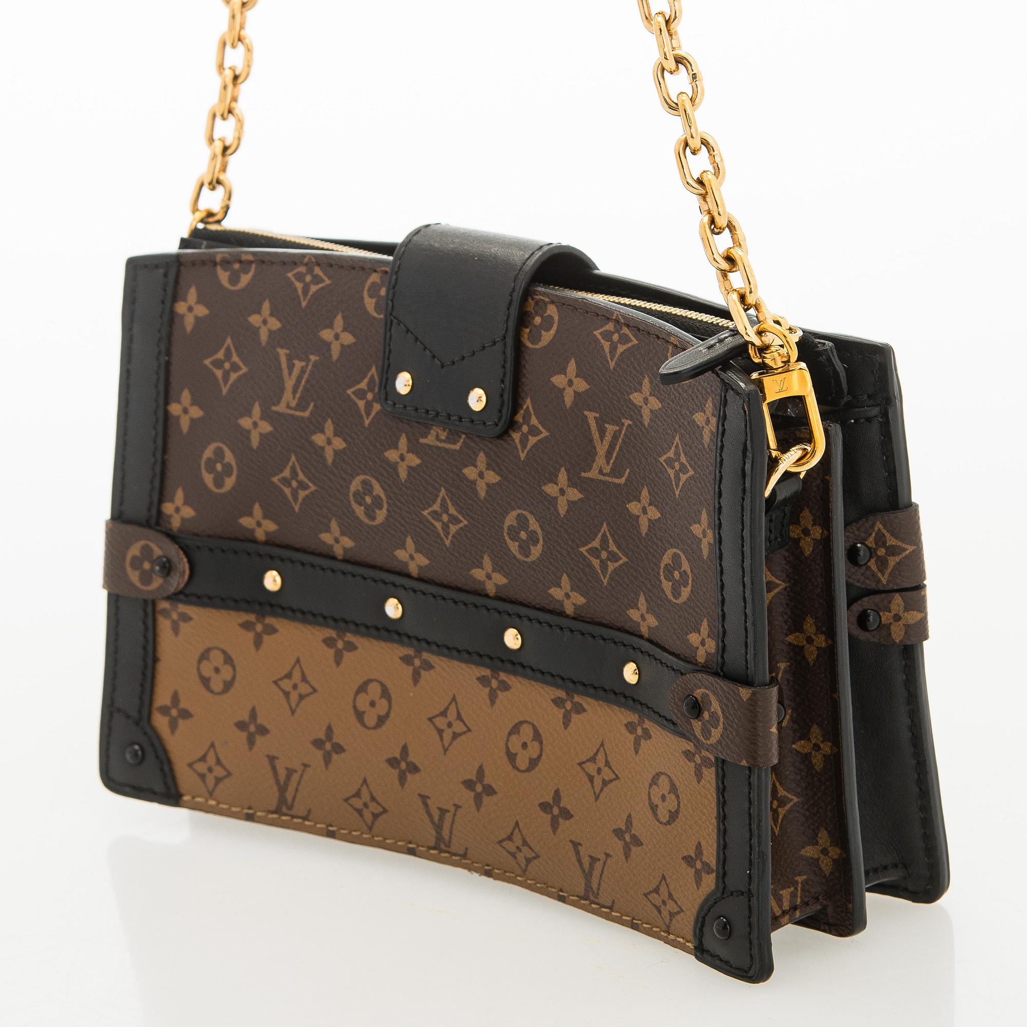 Louis Vuitton, a "Reverse Monogram Trunk Clutch" bag.