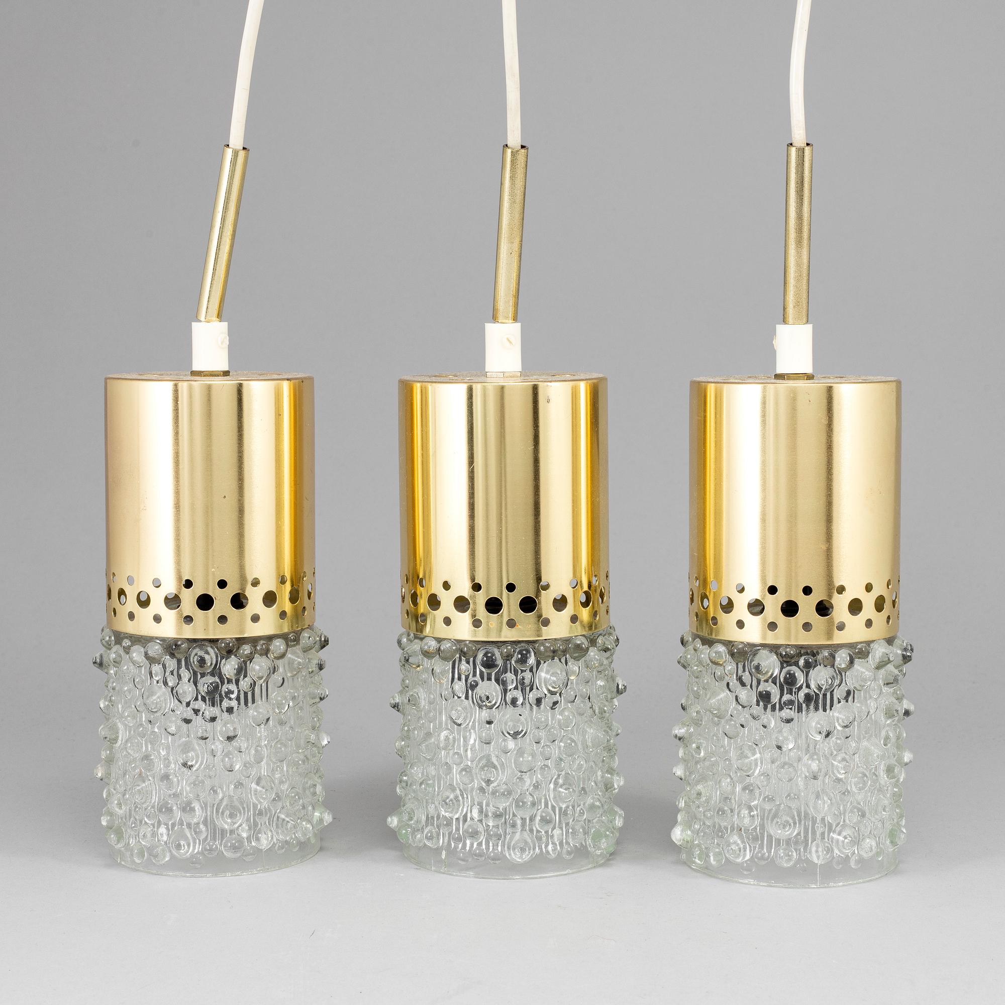 Three brass and glass pendant lights, 1960's.