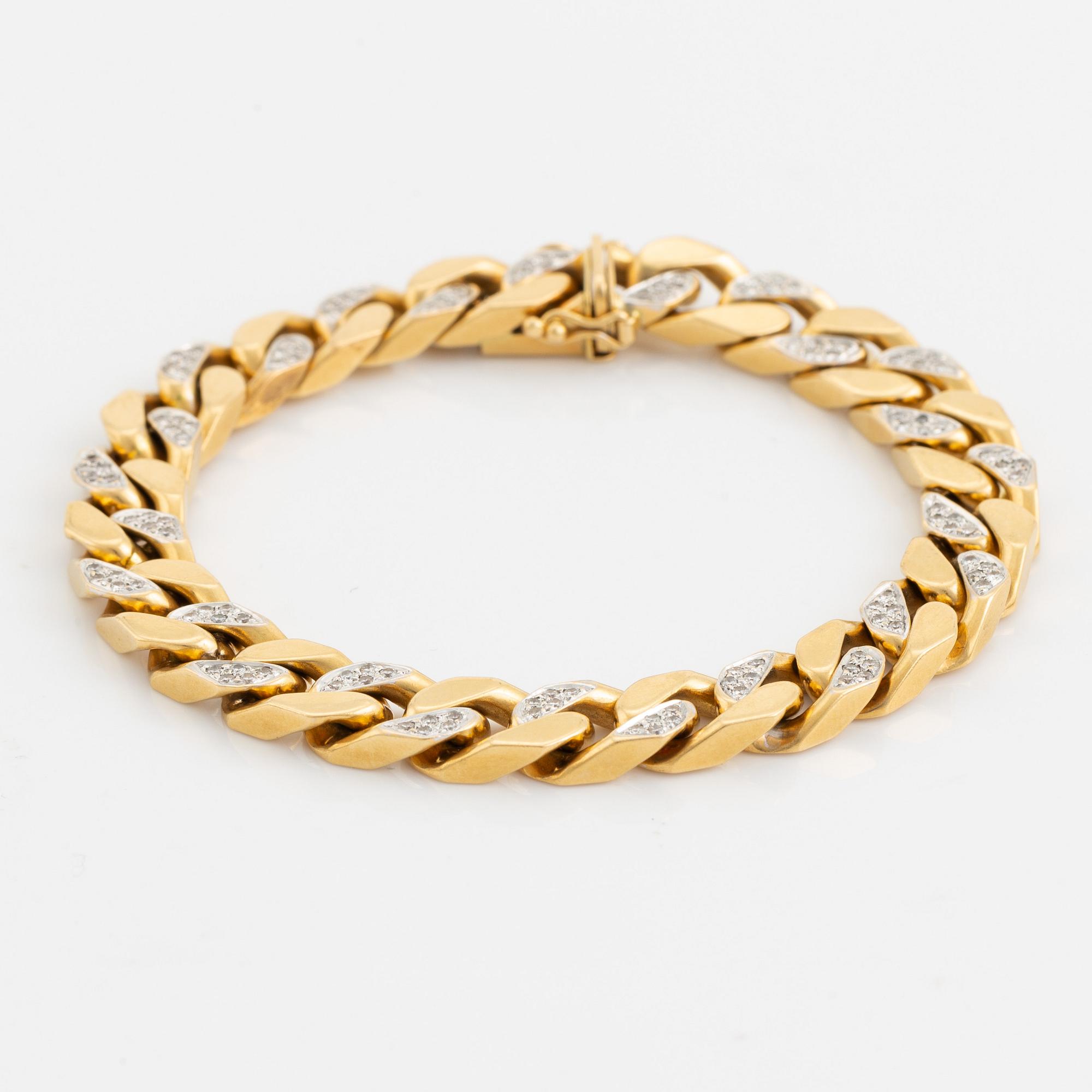 18K gold and brilliant cut diamond curb link bracelet.