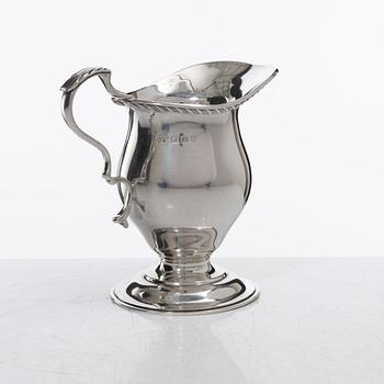 A silver cream jug, mark of S W Smith & Co, Birmingham, England 1929.