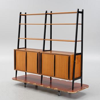 Teak veneered book cases with cabinets.