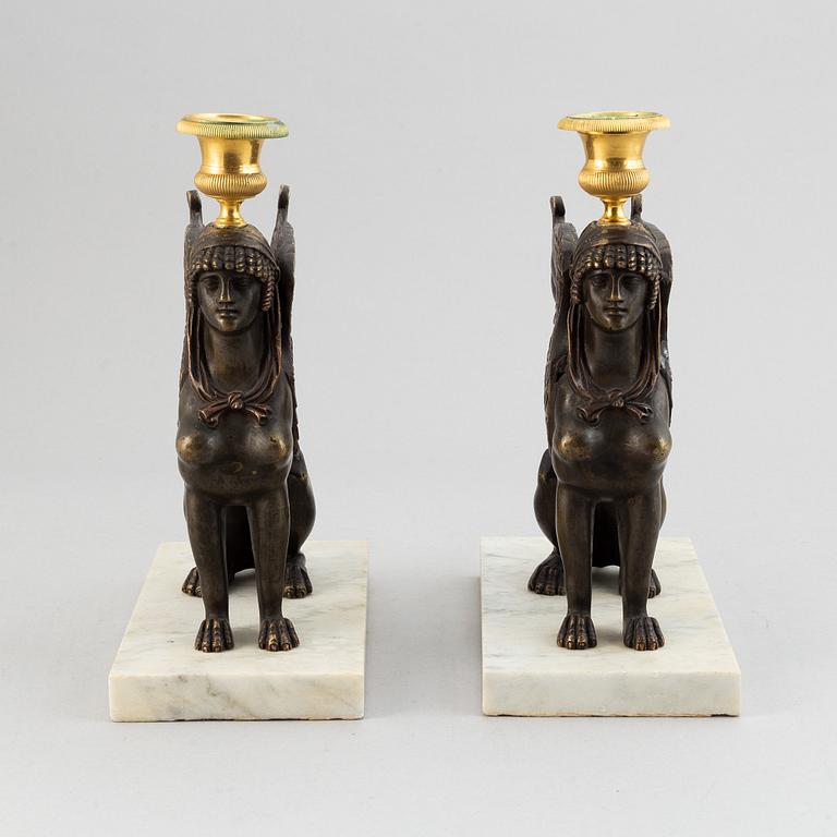 A pair of bronze and marble Empire style candlesticks, first part of the 20th Century.