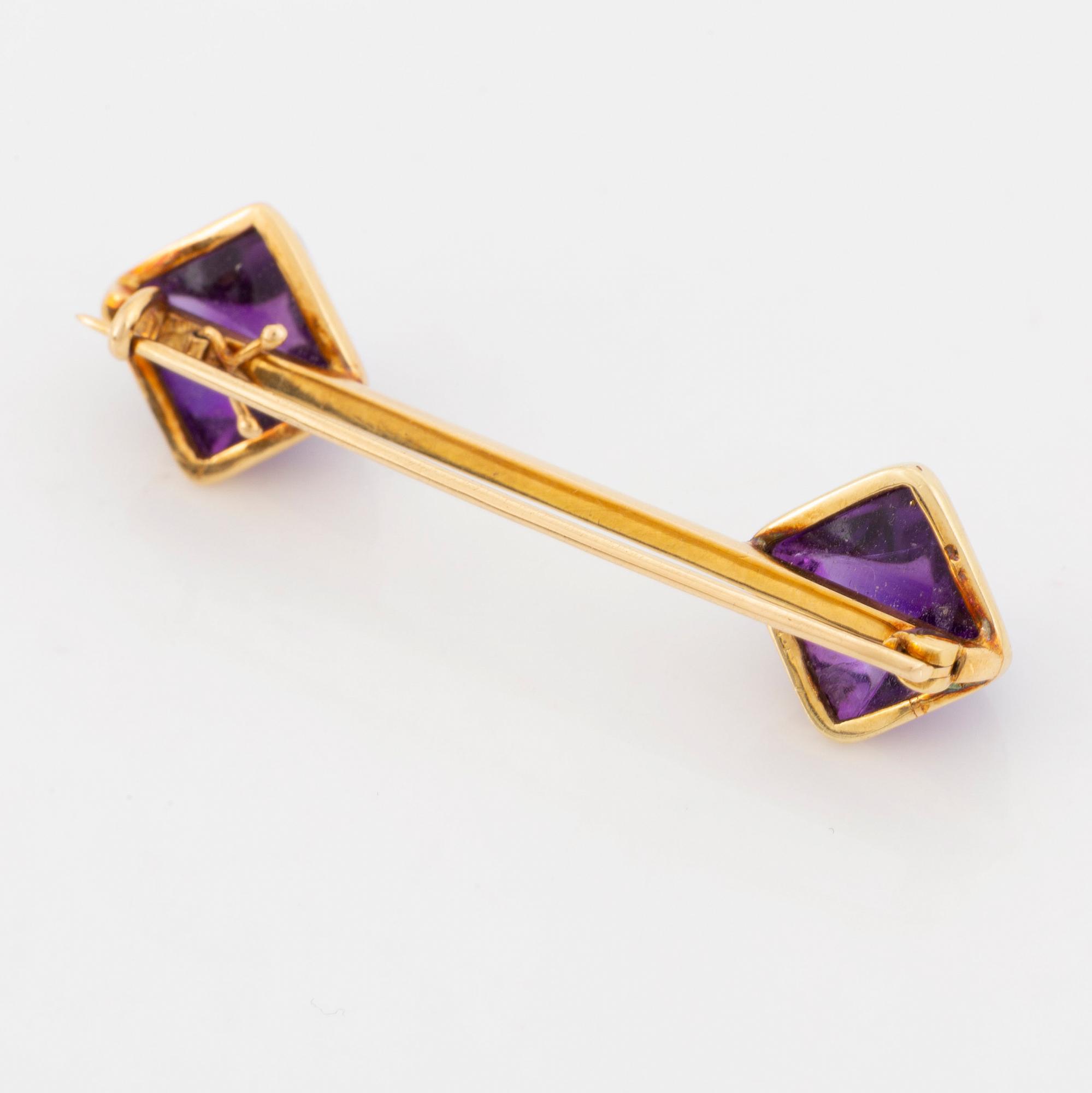 Brooch and earrings with cabochon cut amethysts.