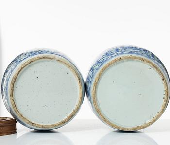 Two similar Chinese blue and white porcealin jars with wooden covers, Qing dynasty, 19th Century.