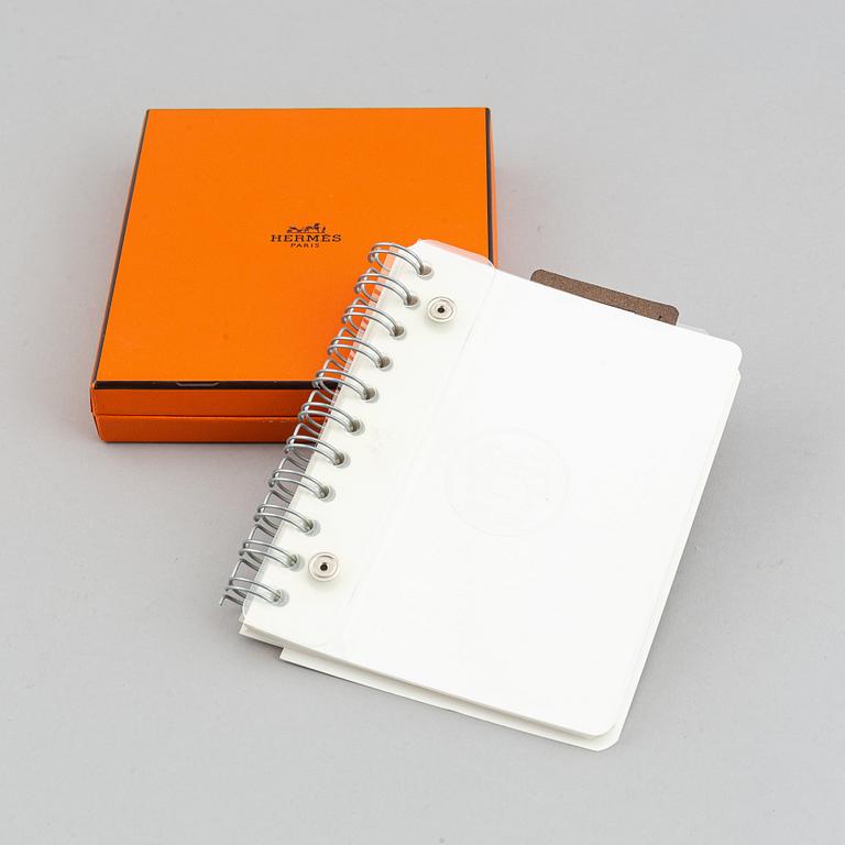 Hermès, a blue leather notebook with two scripple pads.