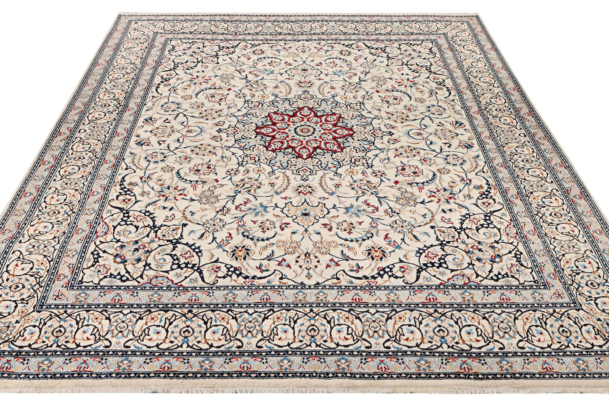 A Nain carpet, part silk, 9 laa, c. 390 x 295 cm.
