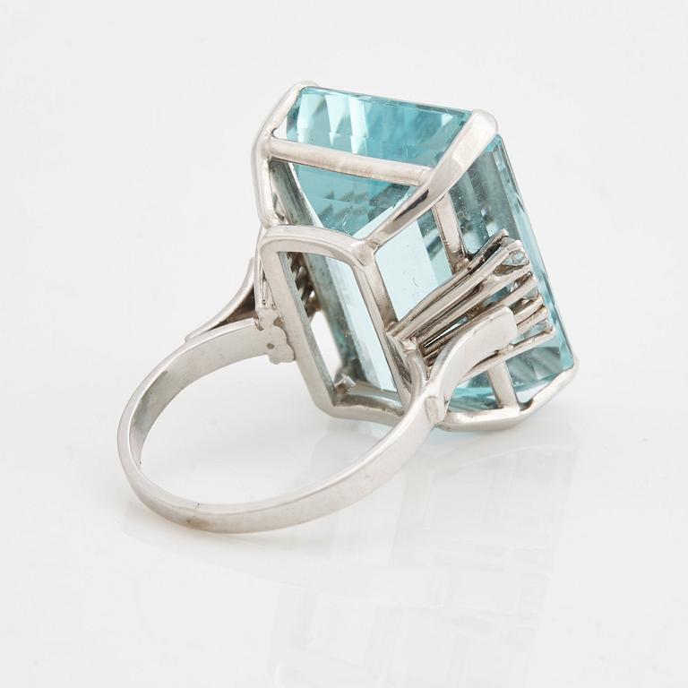 A emerald cut aquamarine and brilliant cut diamond ring.