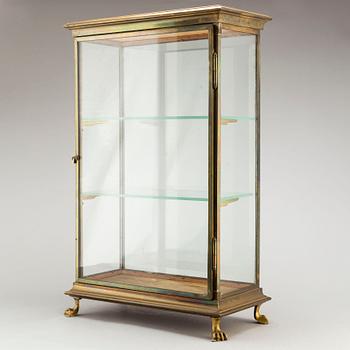 A brass and glass display cabinet, first half of the 20th Century.