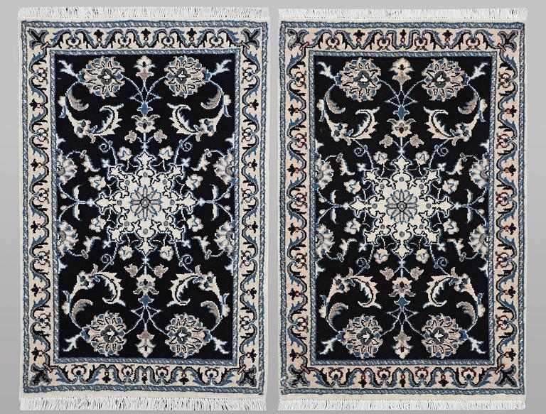 A pair of rugs, Nain, part silk, ca. 90 x 59 cm & ca. 89 x 58 cm.