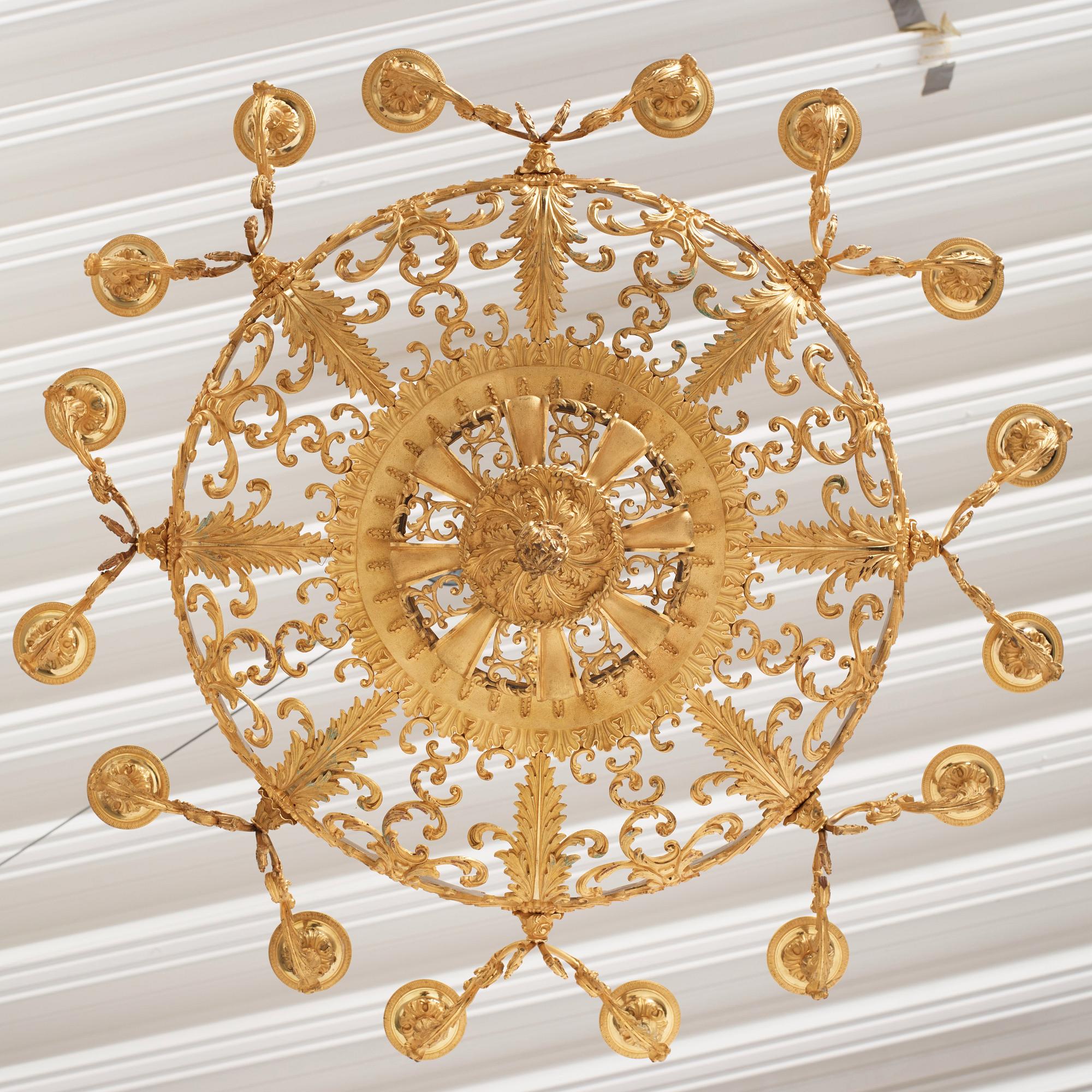 A rococo-revival gilt-brass sixteen-light chandelier, mid 19th century.