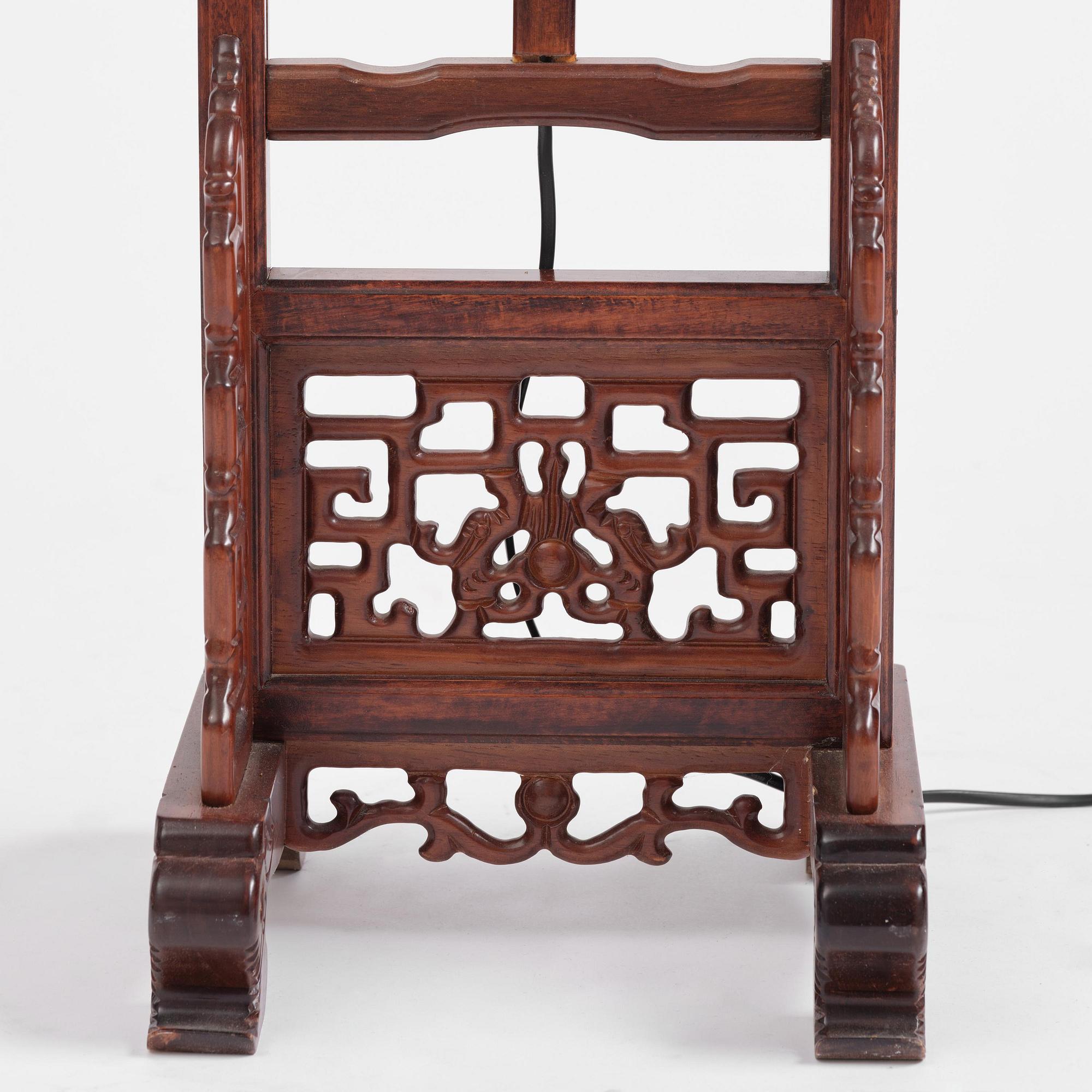 A Chinese wooden floor lamp, later part of the 20th century.