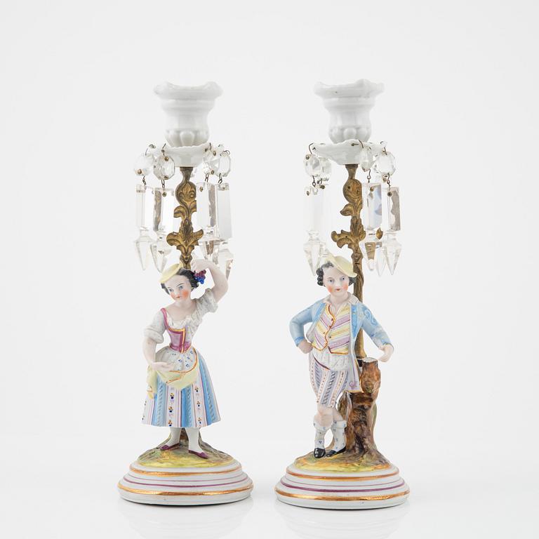 A pair of porcelain Rococo style candlesticks, late 19th Century.