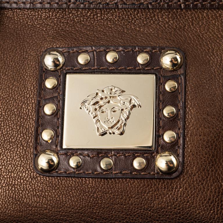 Versace, a bronze metallic leather handbag.