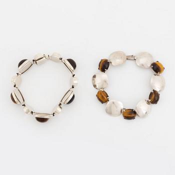 Two silver bracelets set with tiger's eye.