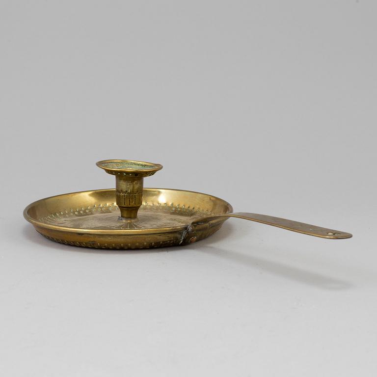 A brass candlestick, 19th century.