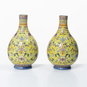 A pair of Chinese yellow ground porcelain vases, 1900s.