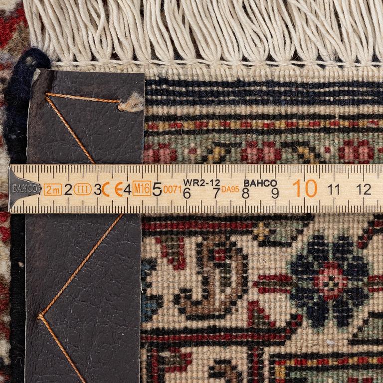 A signed Tabriz carpet, c. 385 x 300 cm.