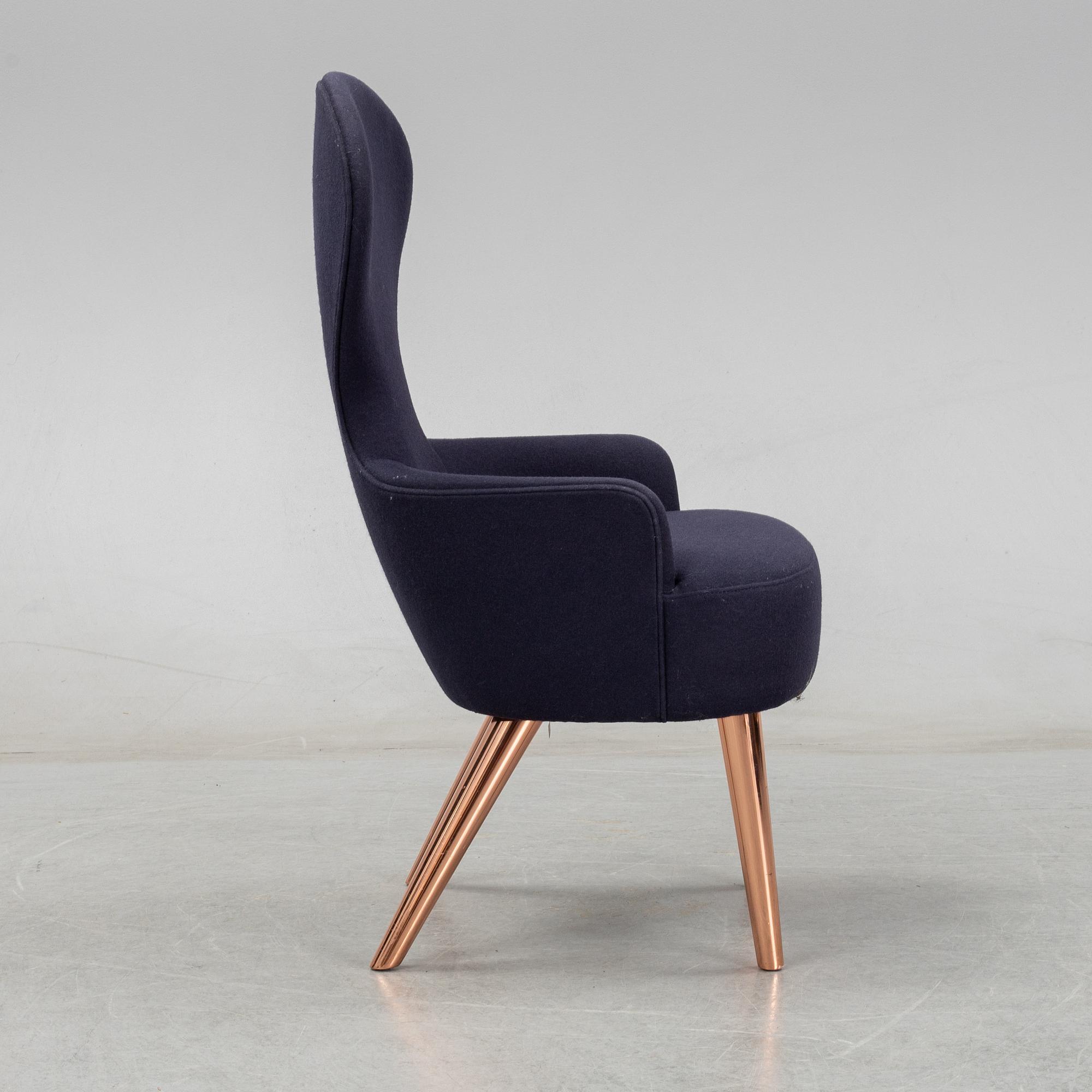 A Tom Dixon "Wingback Dining Chair" from Tom Dixon.