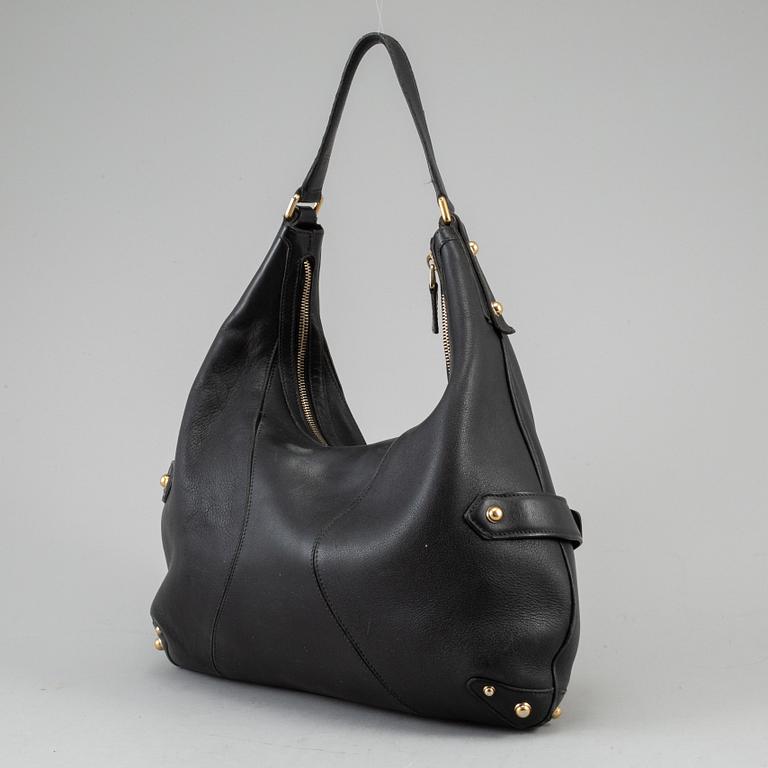 GUCCI, a leather horse-bit bag.