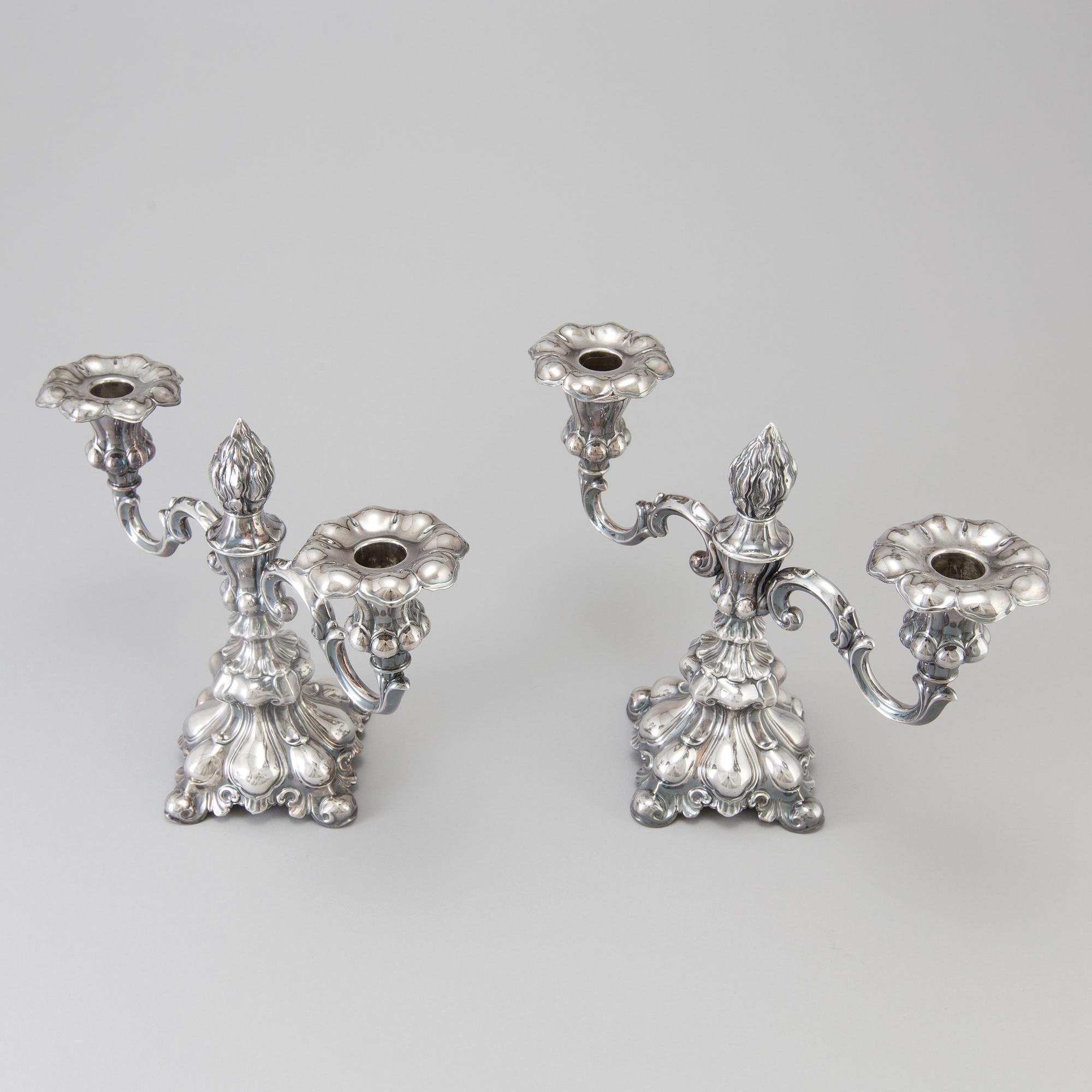 A pair of Swedish Rococo style silver candelabras from C G Hallberg in Stockholm 1955 and 1959.