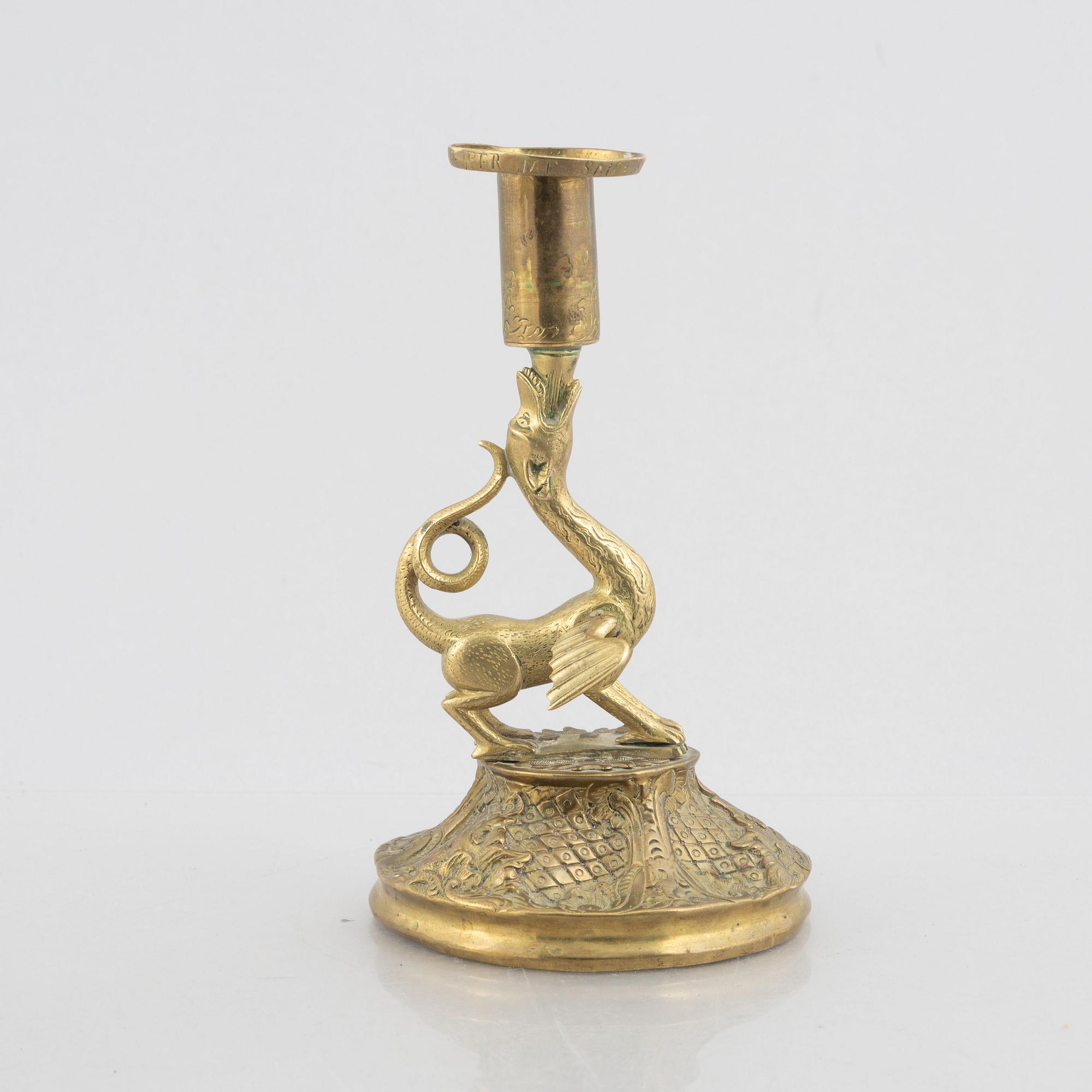 A rococo-style brass candlestick, 18th century and later.