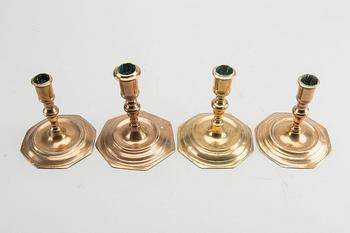 A set of four late Baroque brass candlesticks.