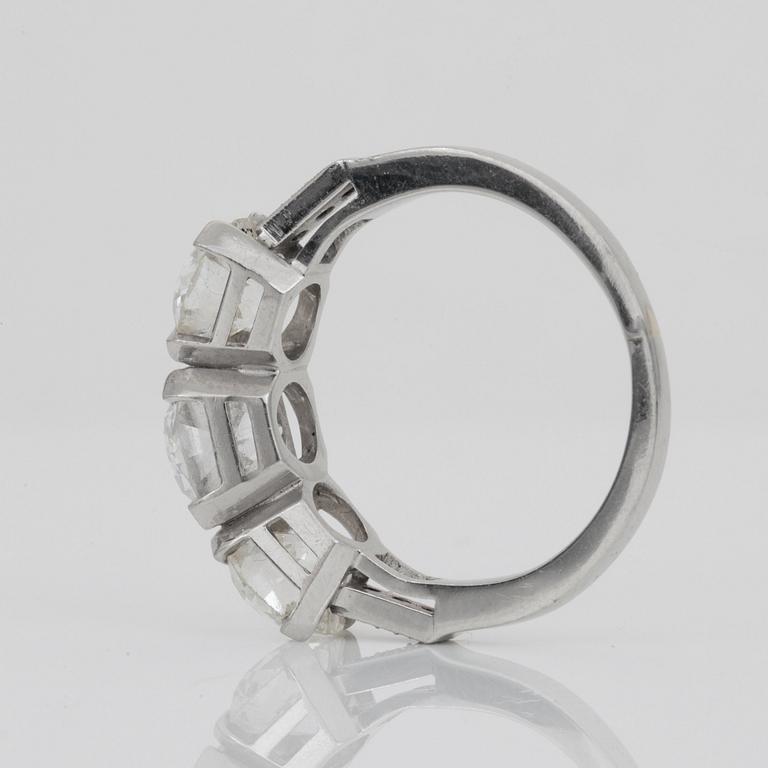 An old-cut three stone diamond ring. Total carat weight circa 3.90 ct.