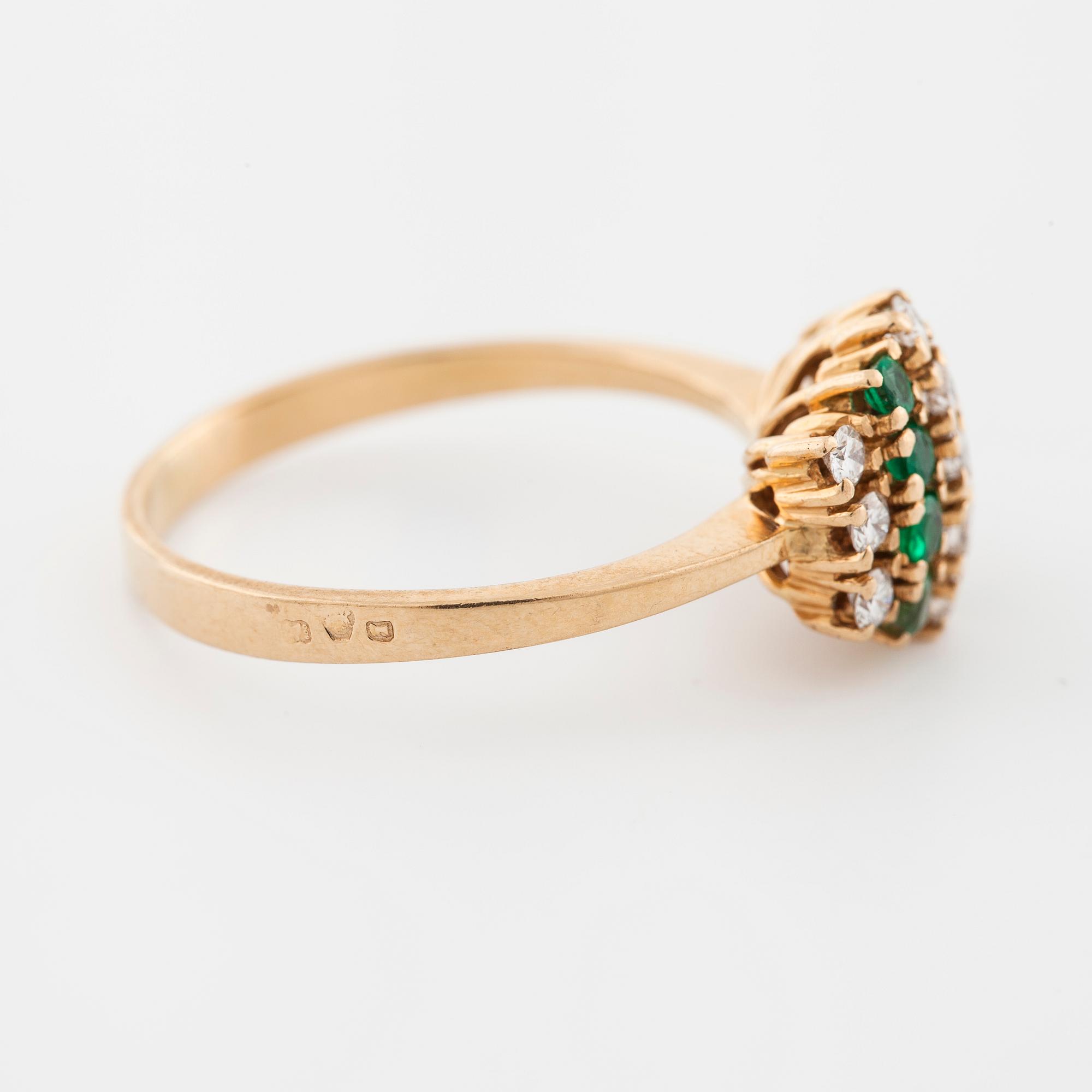 An emerald and brilliant cut diamond ring.