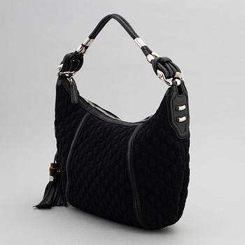 Gucci, a black neoprene handbag.