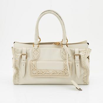 Yves Saint Laurent, a cream coloured goatskin bag with crocheted details.