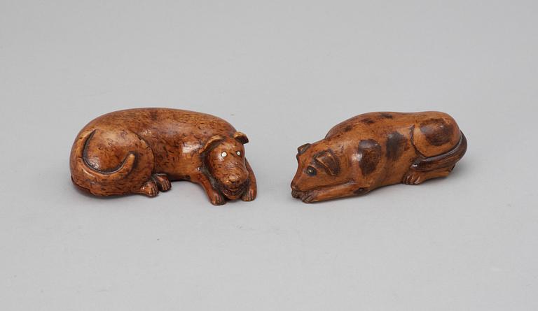 Two 19th-20th century birch snuffboxes in the shape of lying dogs.