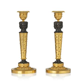 401. A pair of Napoleon III gilt and patinated bronze candlesticks, later part 19th century.